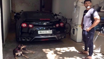 Must See: John Abraham poses for a picture with his Godzilla