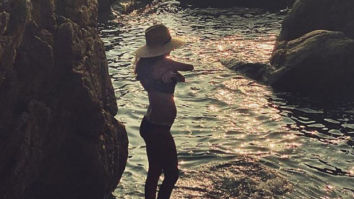 Lisa Haydon flaunts her third baby bump in a bikini as she poses on a beach