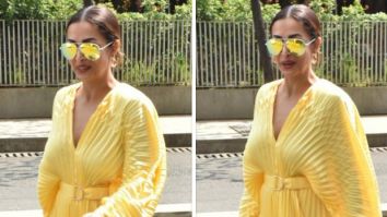 Malaika Arora looks fun and fabulous in a yellow pleated mini dress with a pink Valentino handbag
