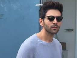 Kartik Aaryan poses with a fan as he gets clicked in the city